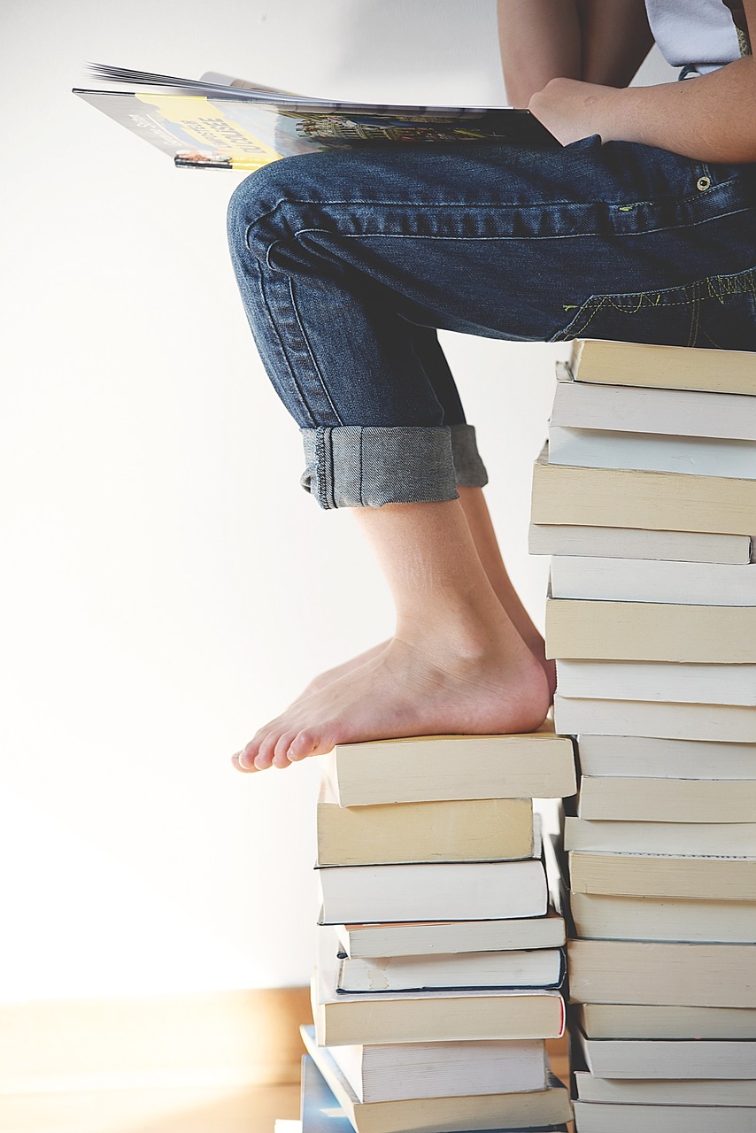 Feet being placed on a pile of books